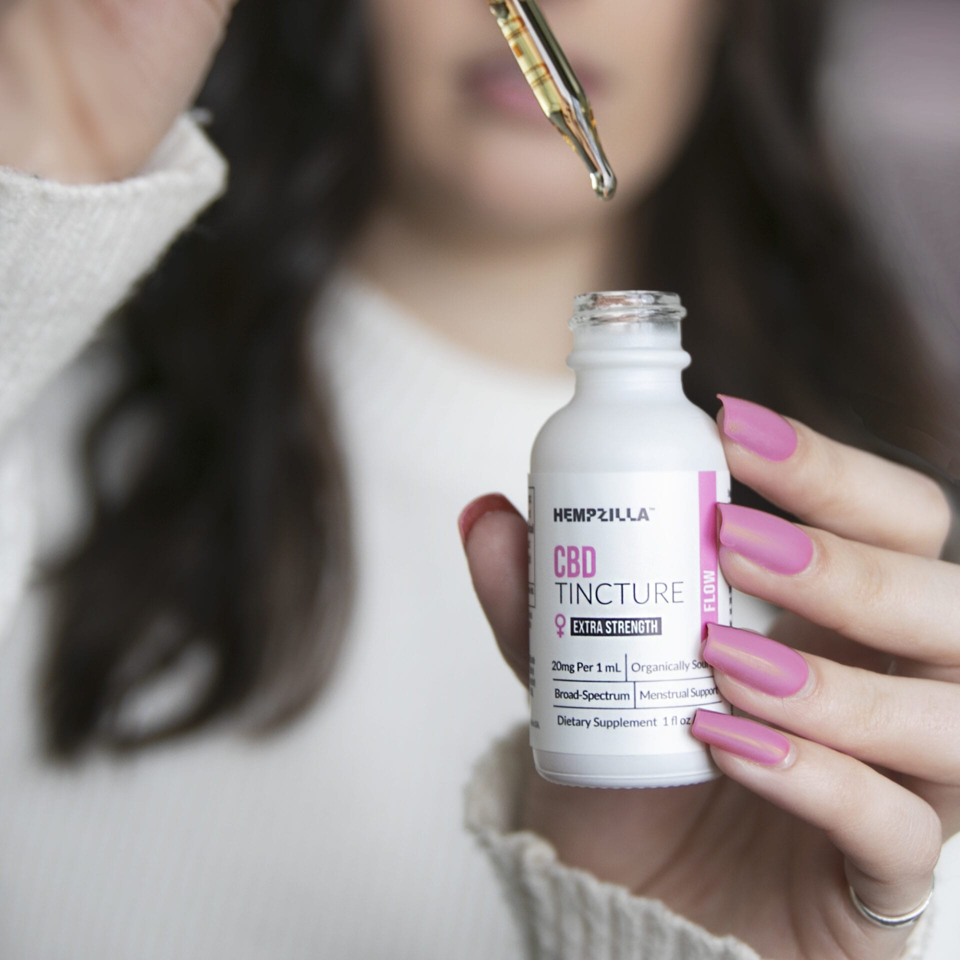 Woman uses one of Hempzilla CBD's organic remedies for PMS